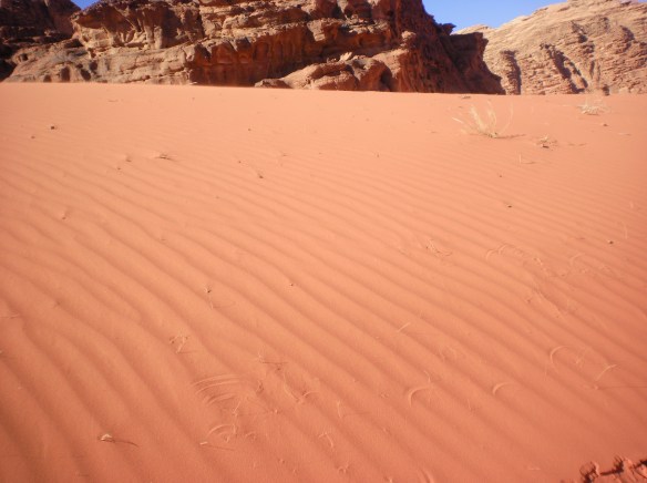 Wind carved sand, follows the paved highways throughout southern Jordan