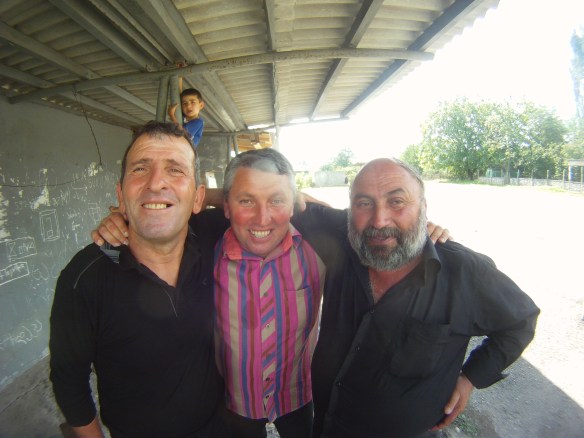 Cheery locals sipping strong drinks in the shade of the afternoon sun